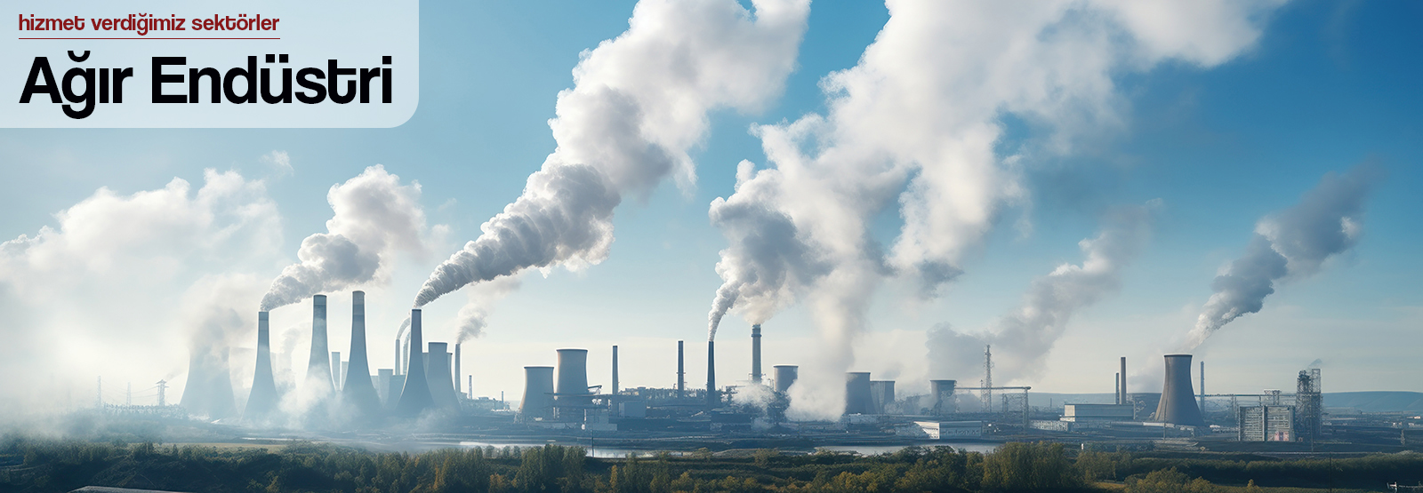 Smokestacks against a clear sky, industrial landscape.