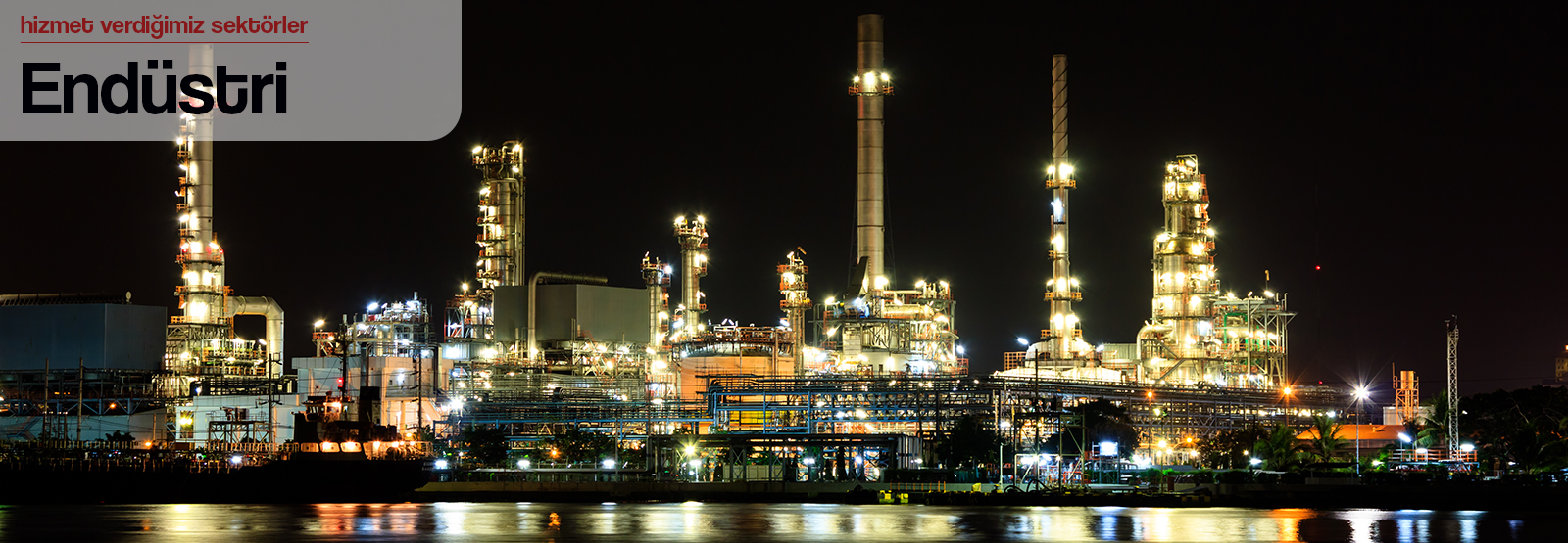 Smokestacks against a clear sky, industrial landscape.